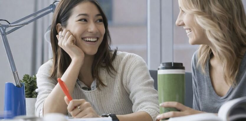 Two students discussing study notes together demonstrating smart learning methods and collaborative learning